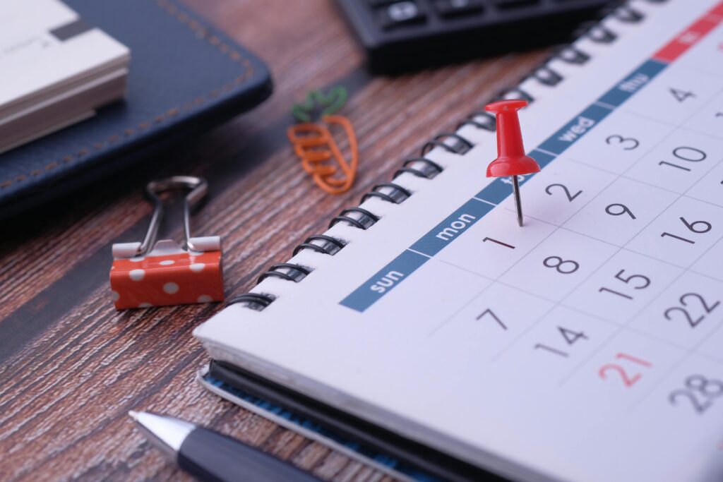 Desk elements like calendar and pins for effective planning.
